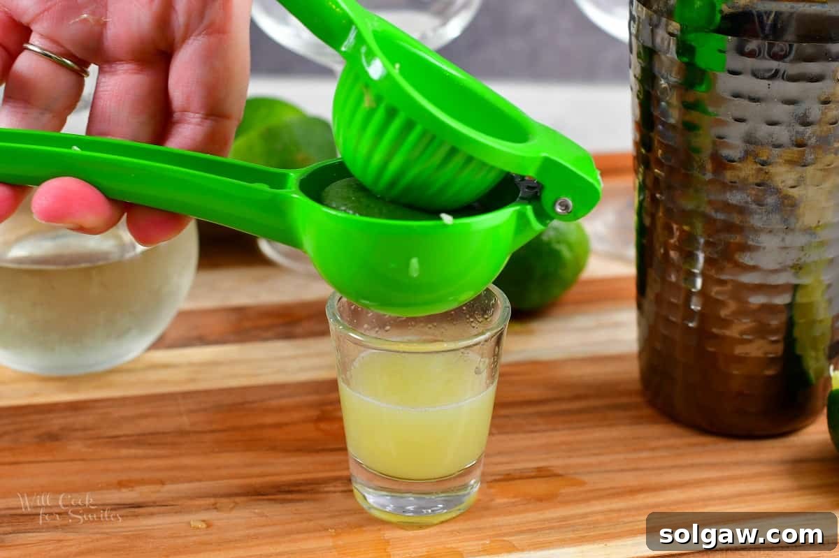 squeezing lime in a lime press