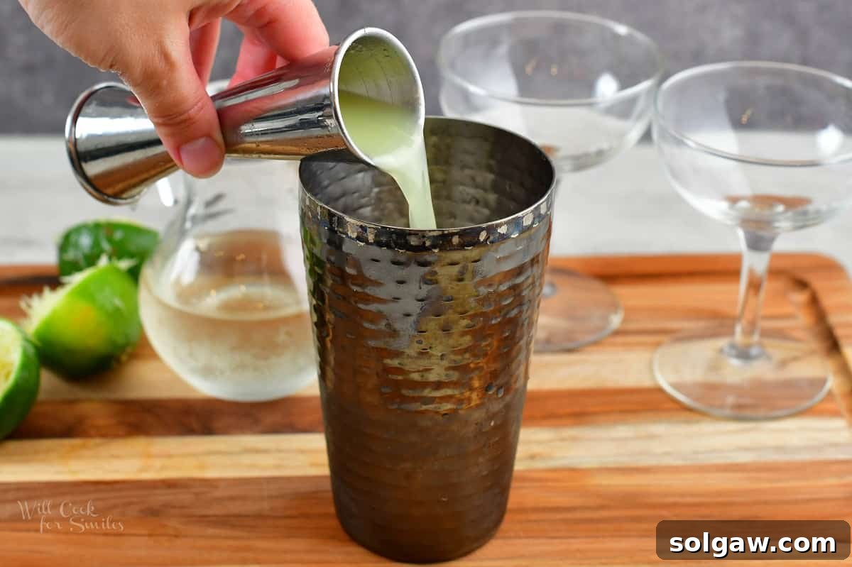 pouring in lime juice into the glass