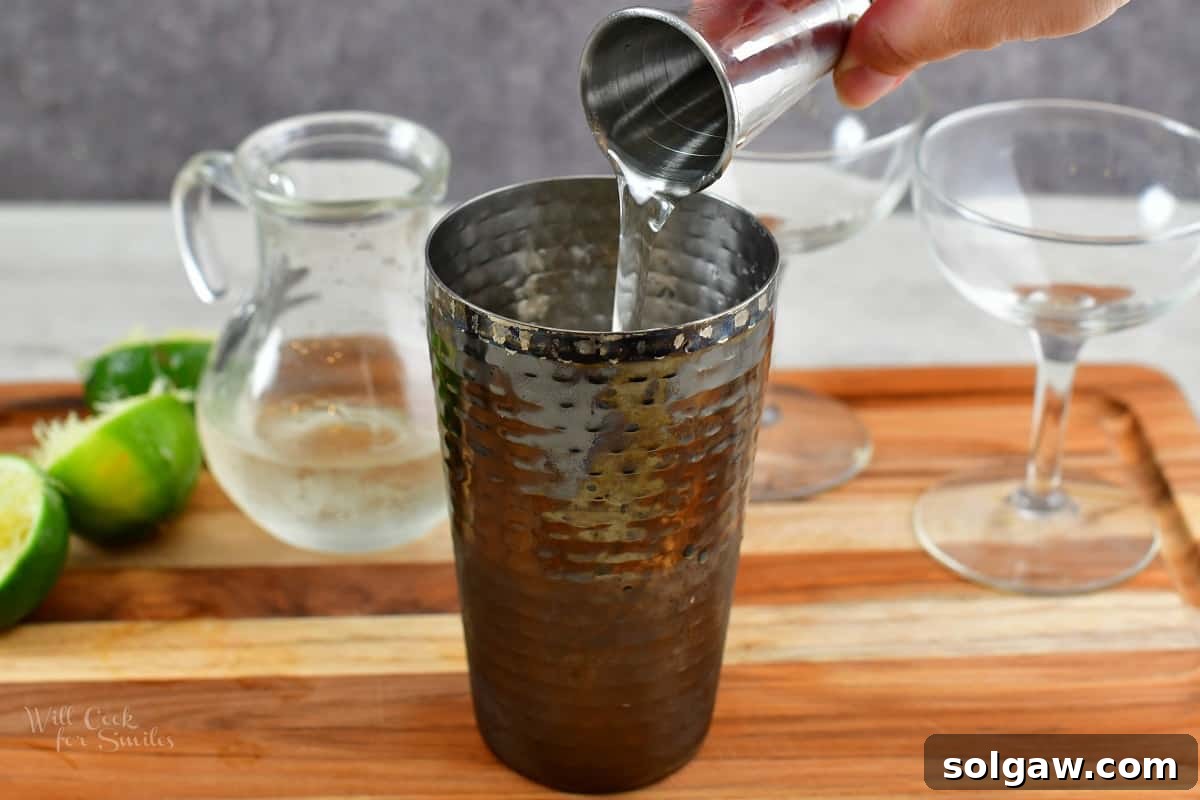 pouring in simple syrup into the glass