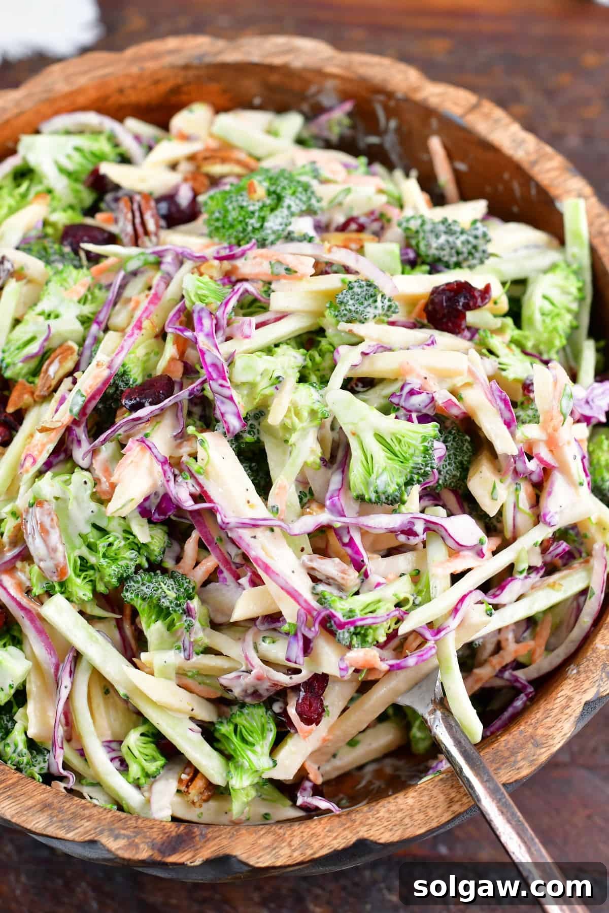 spooning out some broccoli slaw from the bowl