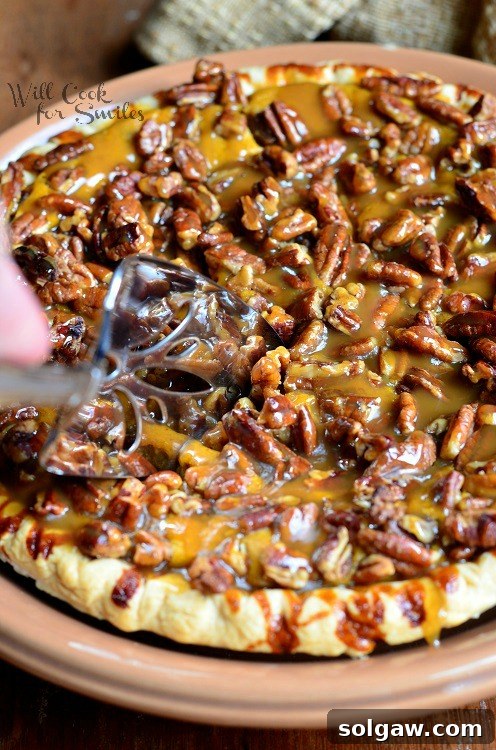 Decadent Pecan Caramel Pumpkin Pie 3 Top-down view of a ready-to-serve Pecan Caramel Pumpkin Cheesecake Pie, glistening with caramel.