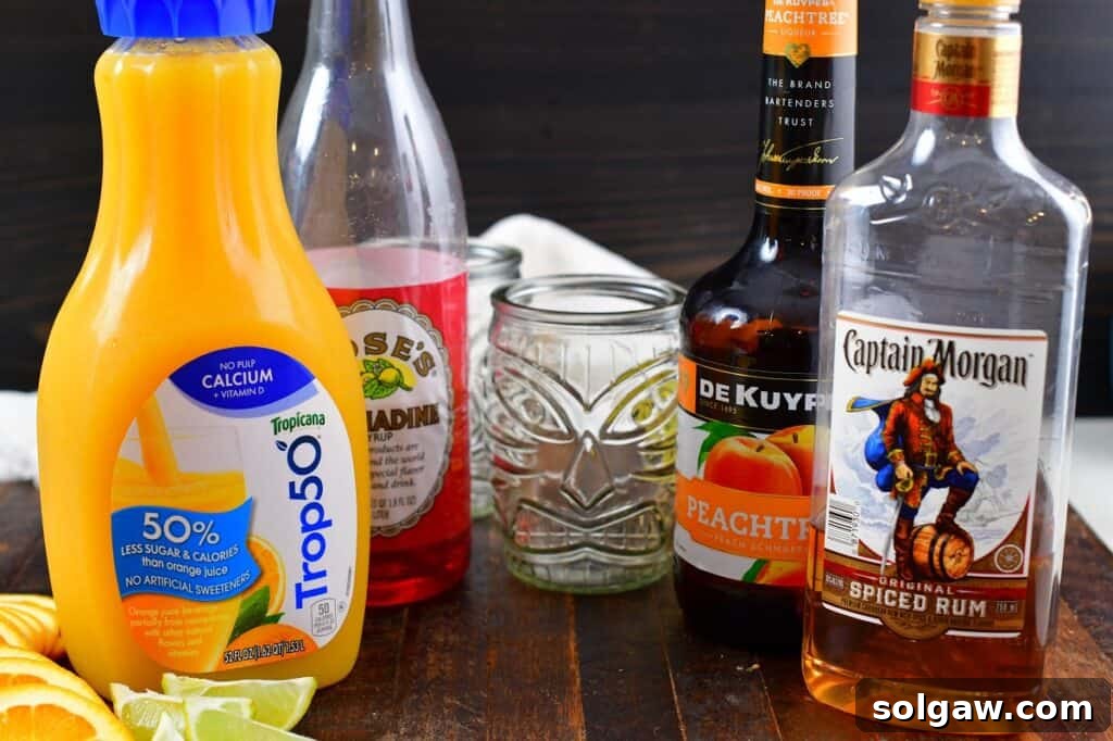 A flat lay of the essential ingredients for a Calypso Cooler cocktail, including a bottle of spiced rum, peach schnapps, fresh oranges, limes, and grenadine, ready for mixing.