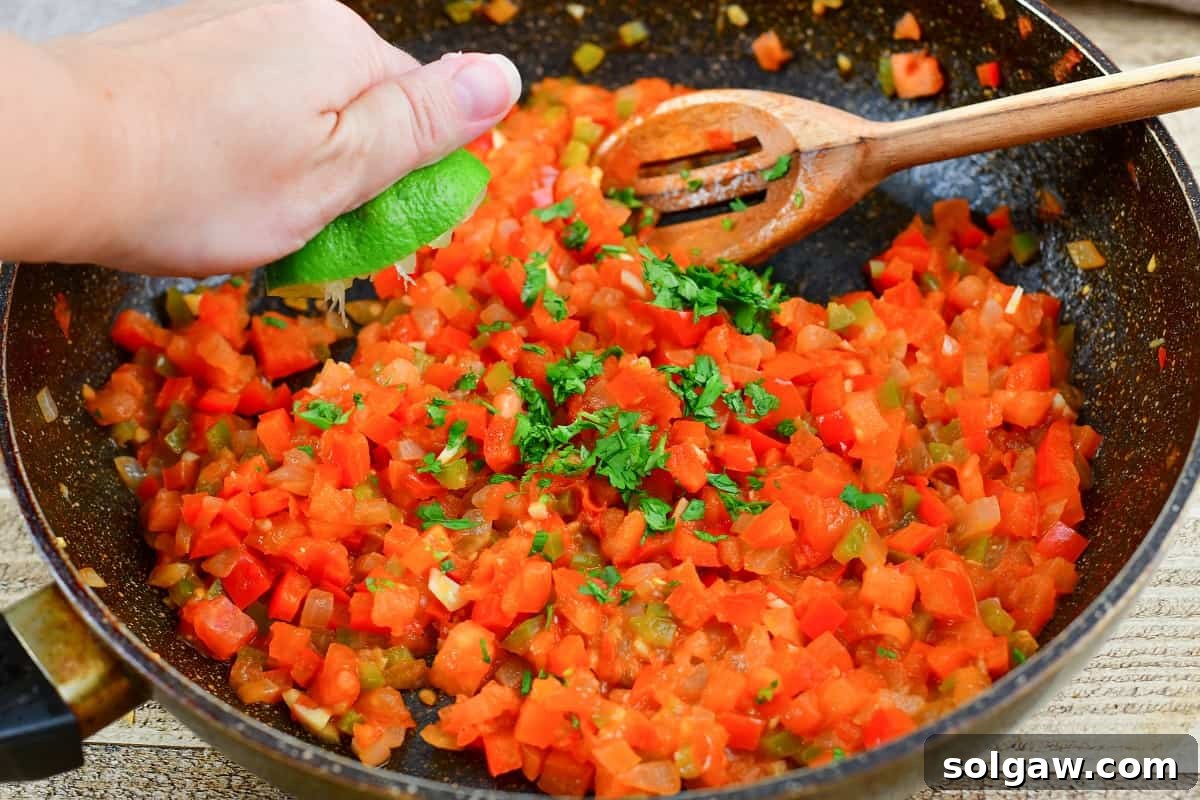 A close-up view of the freshly cooked tomato and vegetable salsa bubbling gently in a pan.