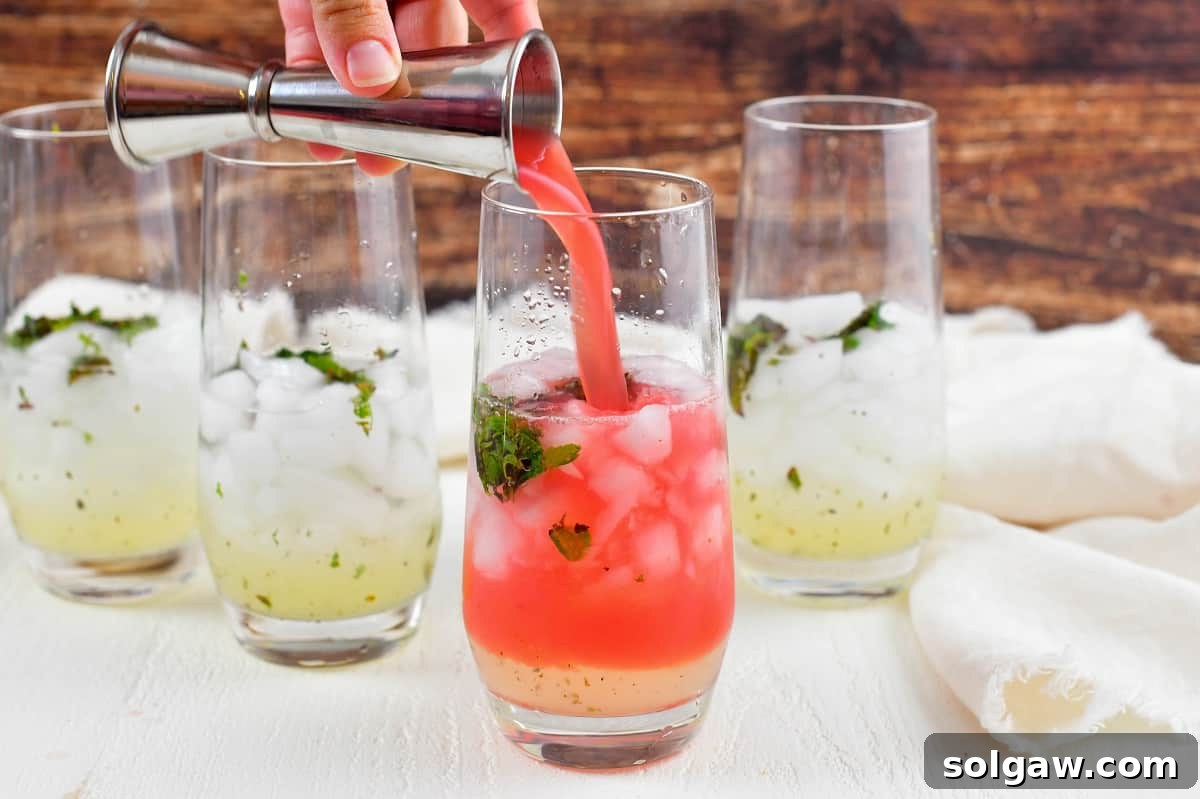 Adding watermelon juice to glasses with mojito ingredients