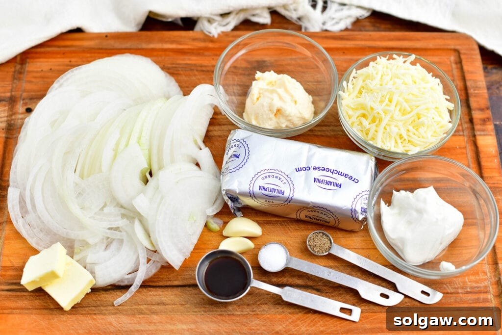 ingredients for onion dip recipe on a wooden cutting board