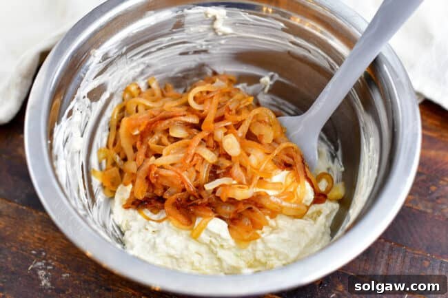 stirring caramelized onions into other onion dip recipe ingredients