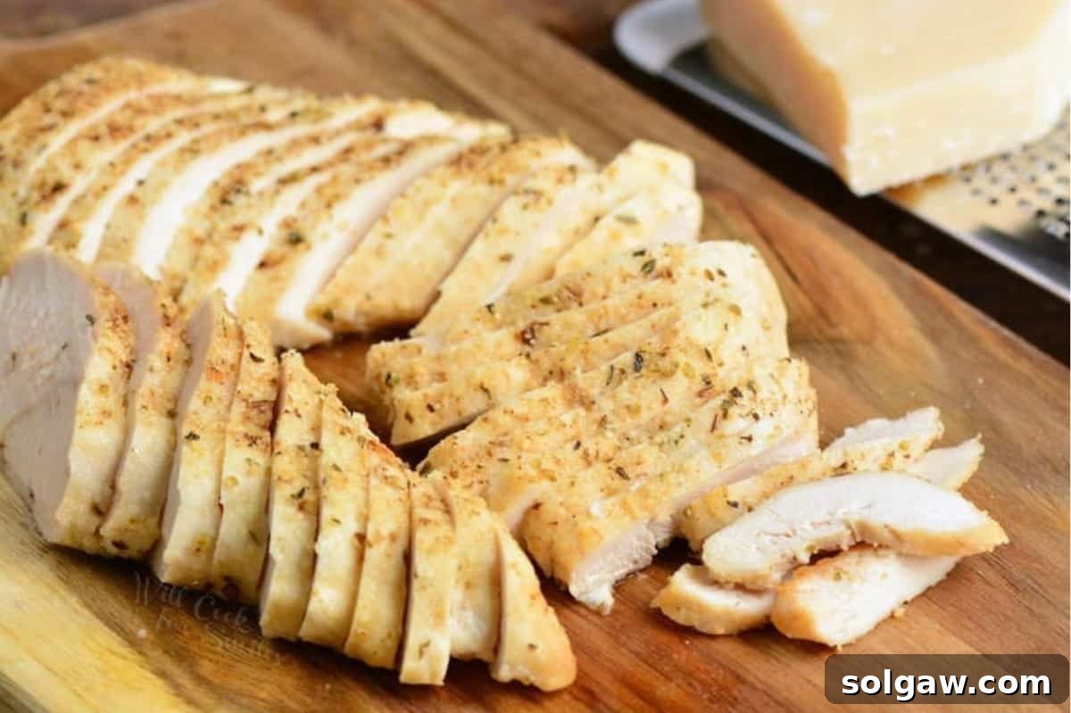 sliced chicken on a wood cutting board.