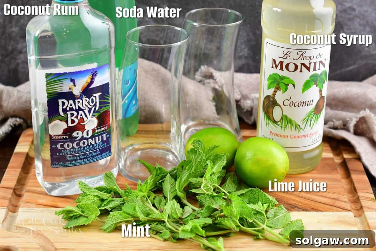 Labeled ingredients for coconut mojito on a rustic wooden board.
