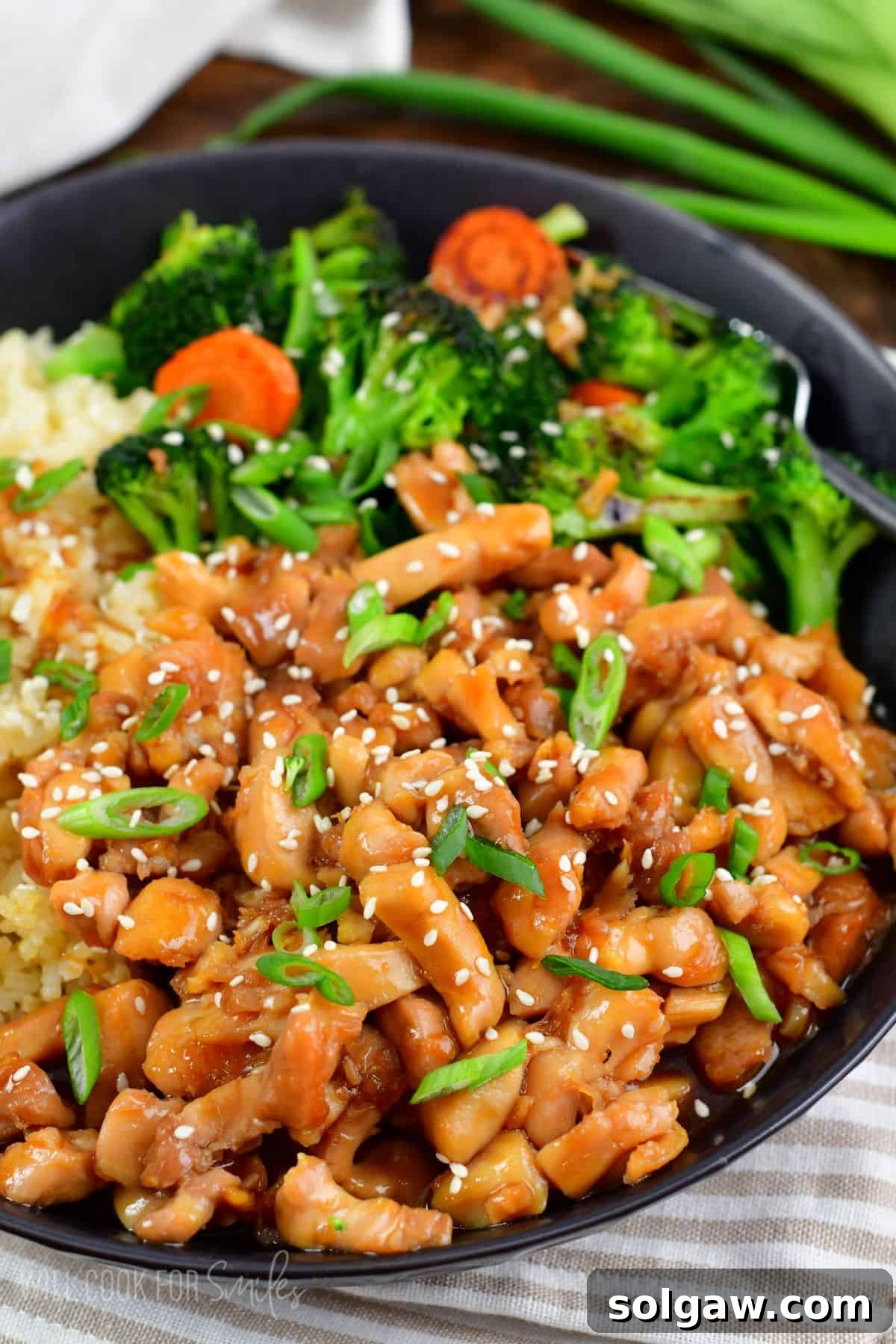 chicken teriyaki in the bowl with rice and some veggies.