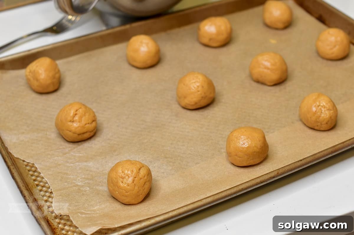 rolled cookie dough balls on the baking sheet.