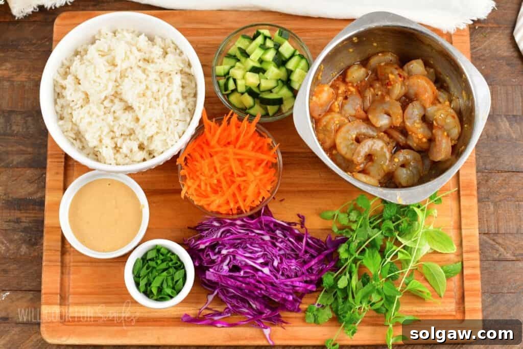 Fresh Spring Roll Bowl 4 A cutting board displays fresh ingredients for a spring roll bowl, including uncooked shrimp, various vegetables, and components for the peanut sauce.