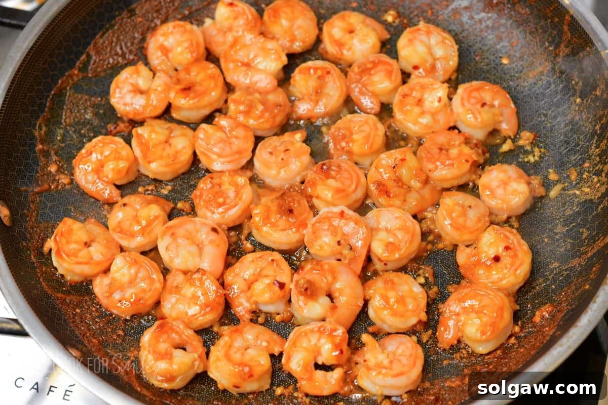 Fresh Spring Roll Bowl 6 Perfectly cooked shrimp coated in a flavorful Thai sauce, resting in a pan after searing.