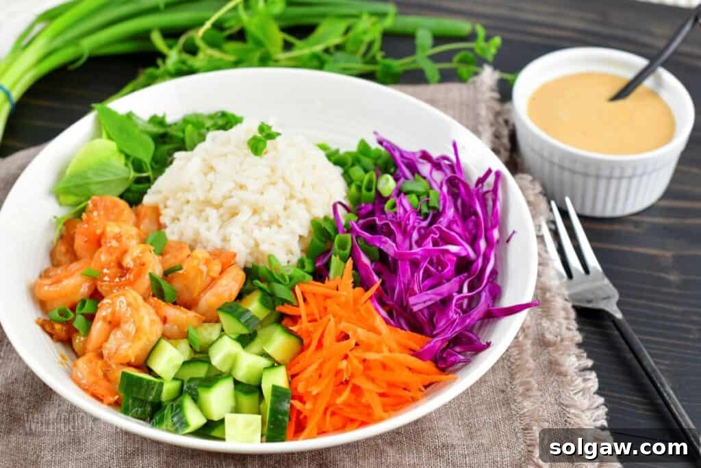 Fresh Spring Roll Bowl 7 Side view of a spring roll rice bowl featuring fluffy coconut rice, juicy shrimp, crisp vegetables, ready for dressing.