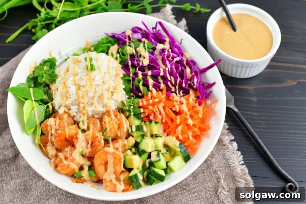 Fresh Spring Roll Bowl 8 Top view of a freshly assembled spring roll rice bowl, beautifully drizzled with rich peanut sauce, showcasing vibrant ingredients.