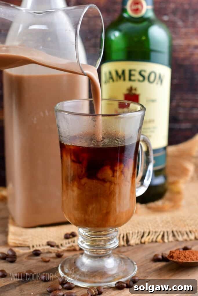 pouring creamy cocktail into a mug of coffee.