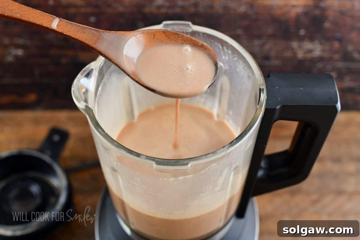 Spooning out Irish cream from the blender.