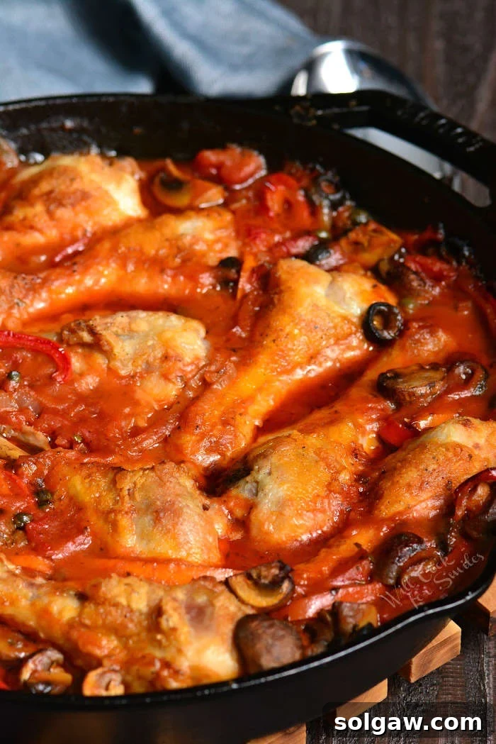 Finished Chicken Cacciatore dish in a cast iron pan, ready to serve