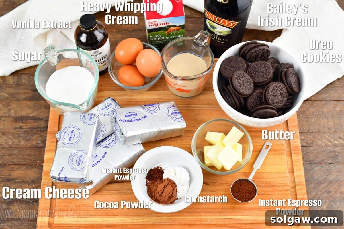 labeled ingredients to make Baileys cheesecake on a wooden cutting board.