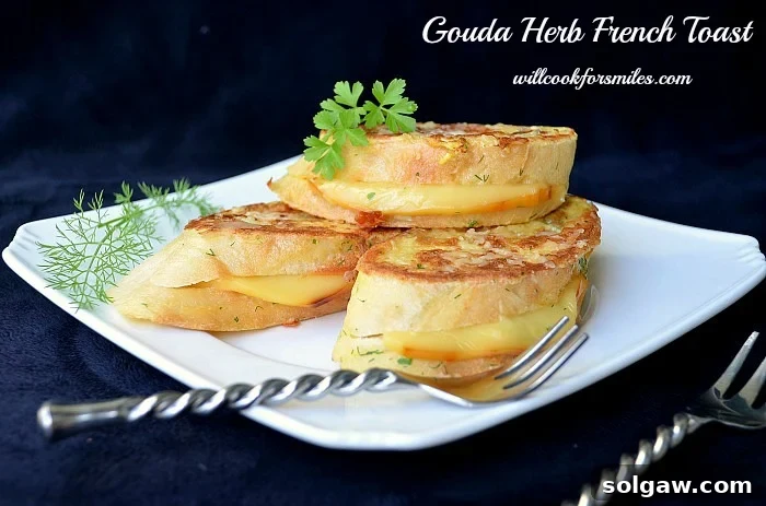 A close-up of Gouda Herb Savory French Toast, stacked on a plate with a fork resting beside it, highlighting the texture and melted cheese.