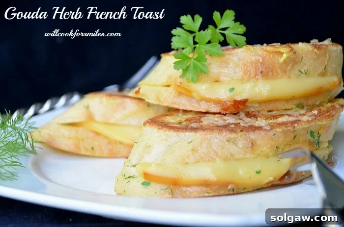 Three slices of Gouda Herb Savory French Toast stacked on a plate, garnished with more fresh herbs, ready to be served.