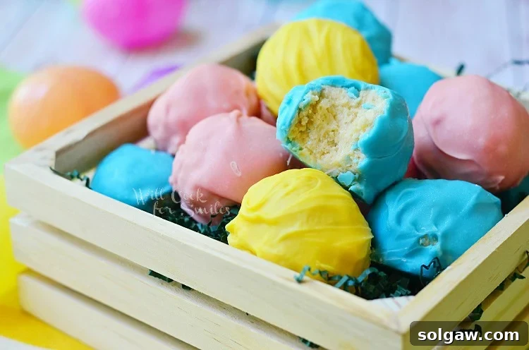 Easter Marshmallow Oreo Truffles in a wood box with a bite out of one of one 