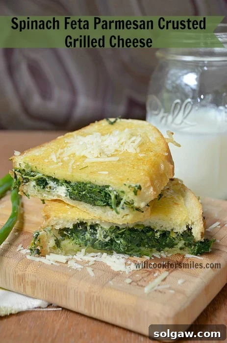 A crispy Spinach Feta Parmesan Crusted Grilled Cheese sandwich, showing its golden crust and flavorful filling.