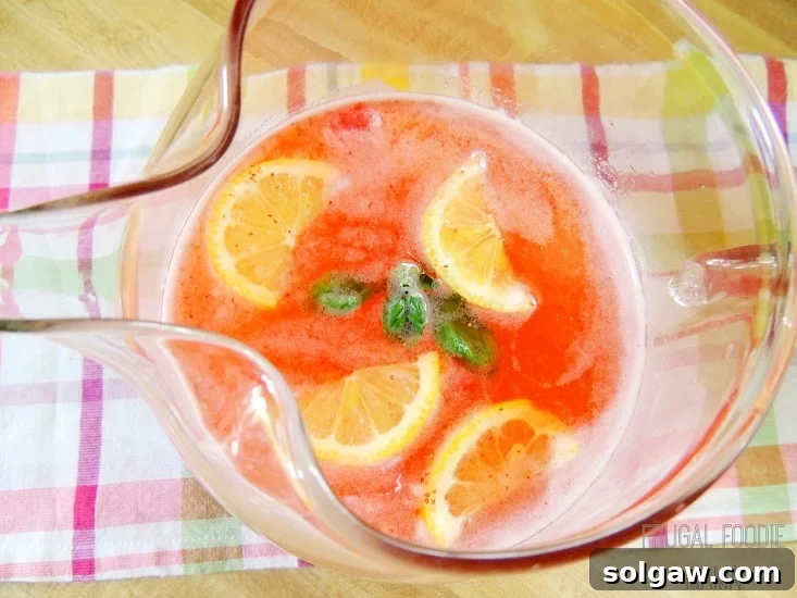 strawberry basil lemonade in a pitcher 