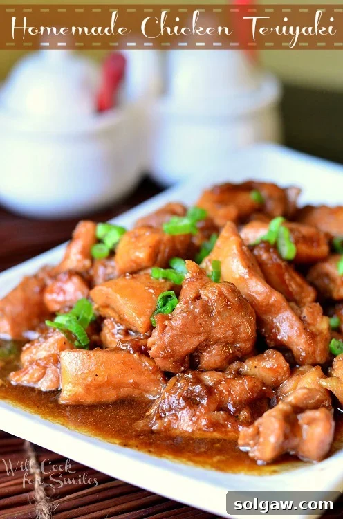 Homemade Chicken Teriyaki served on a plate with steamed rice and green onions, showcasing a glossy teriyaki glaze.