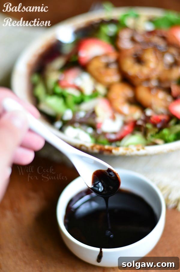 Balsamic Reduction for Balsamic Shrimp Salad in a small bowl with the salad in the background