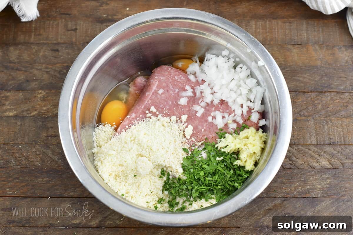 ingredients for the meatballs in a metal bowl.