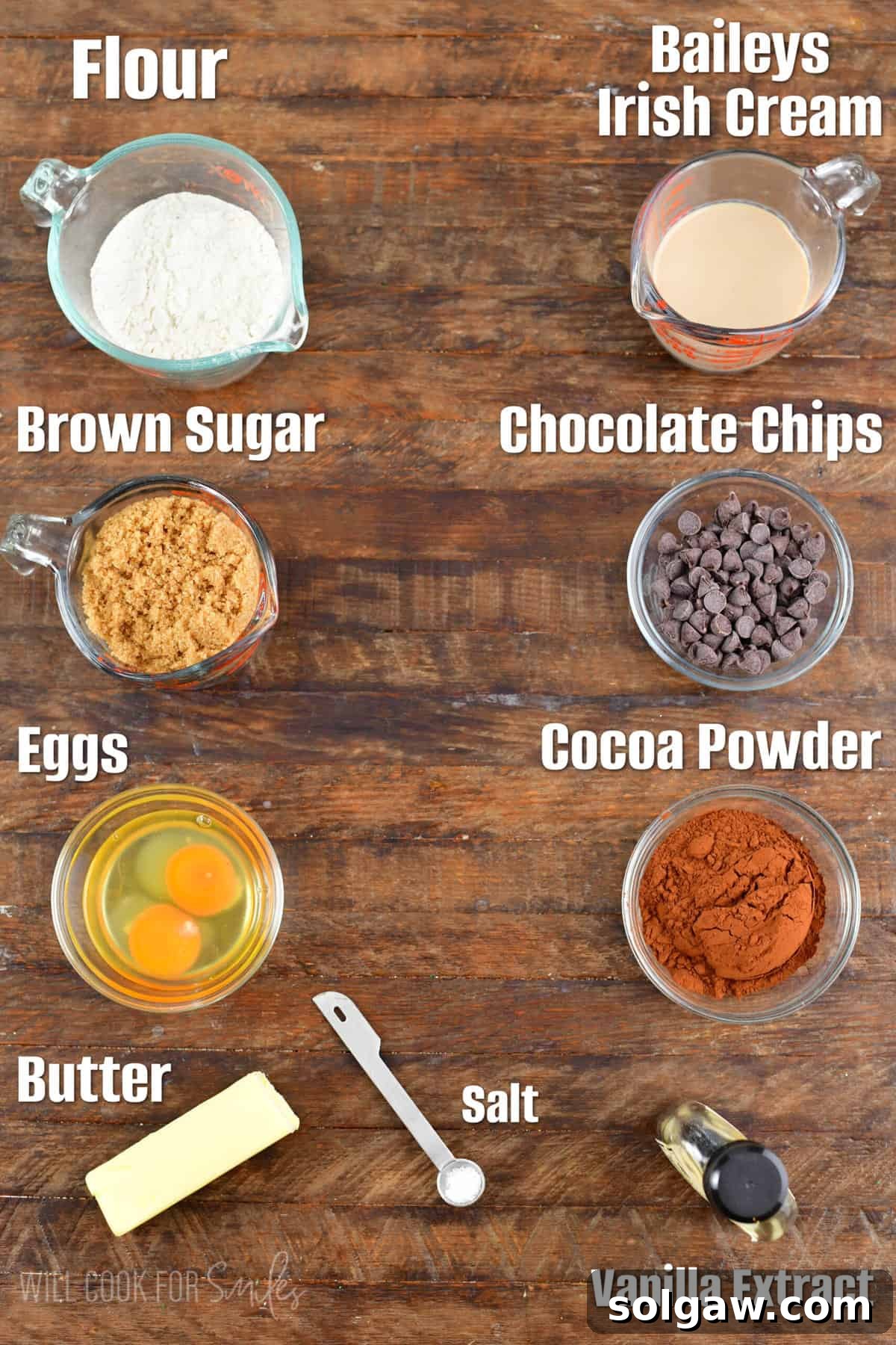 Labeled ingredients for Baileys Brownies on a wood surface.