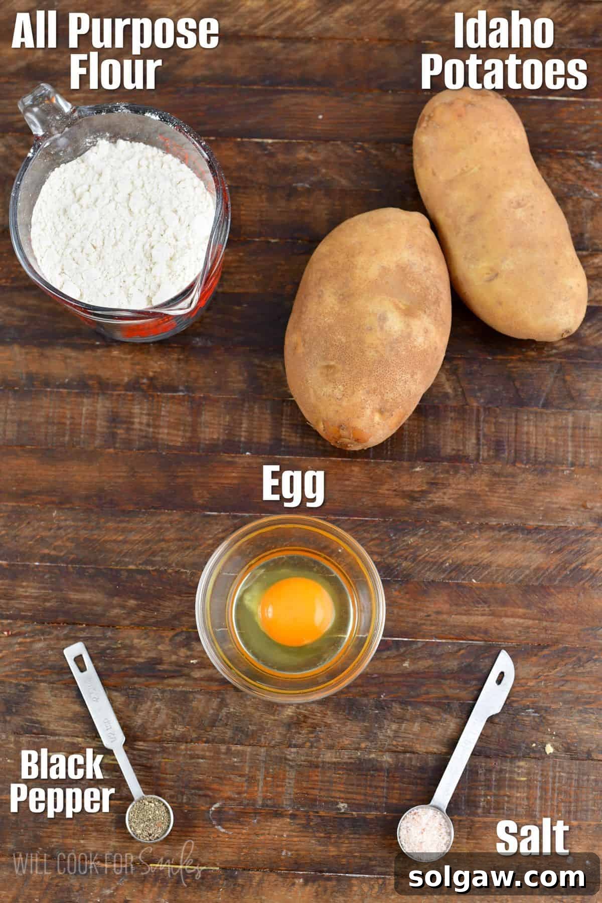 Pillowy Homemade Gnocchi Perfection 3 Labeled ingredients for homemade gnocchi, including Idaho potatoes, flour, and an egg, displayed on a wooden board.