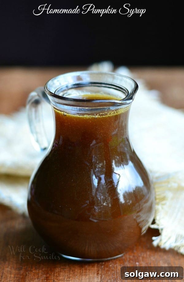 A jar of rich Homemade Pumpkin Syrup ready to be served over pancakes or waffles, celebrating the start of the fall season.