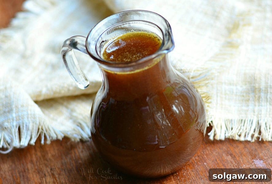 Three jars of Homemade Pumpkin Syrup, showcasing its inviting golden-orange color and smooth texture, perfect for any fall table.