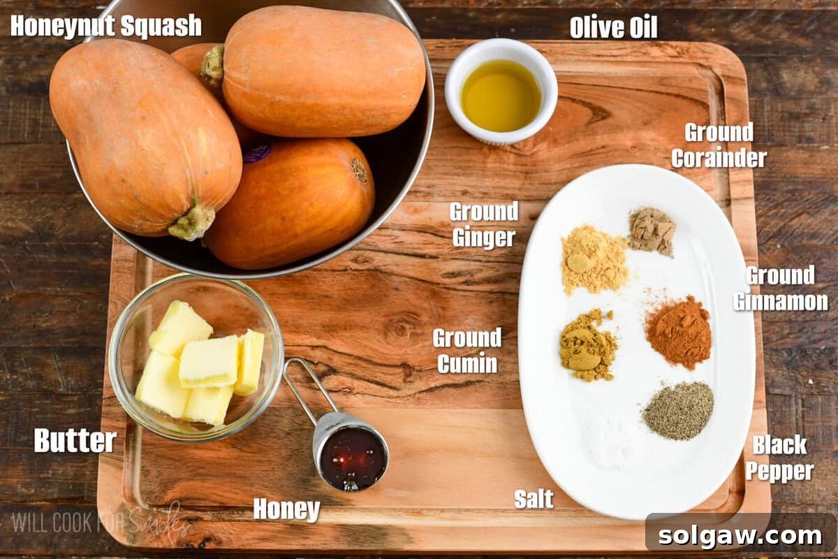 Labeled ingredients for Spiced Roasted Honeynut Squash on a wood surface.