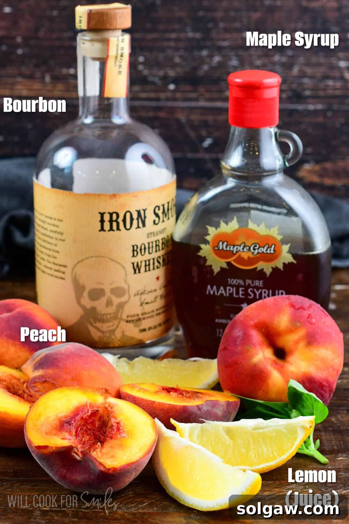 Peach bourbon smash ingredients on a wood surface.