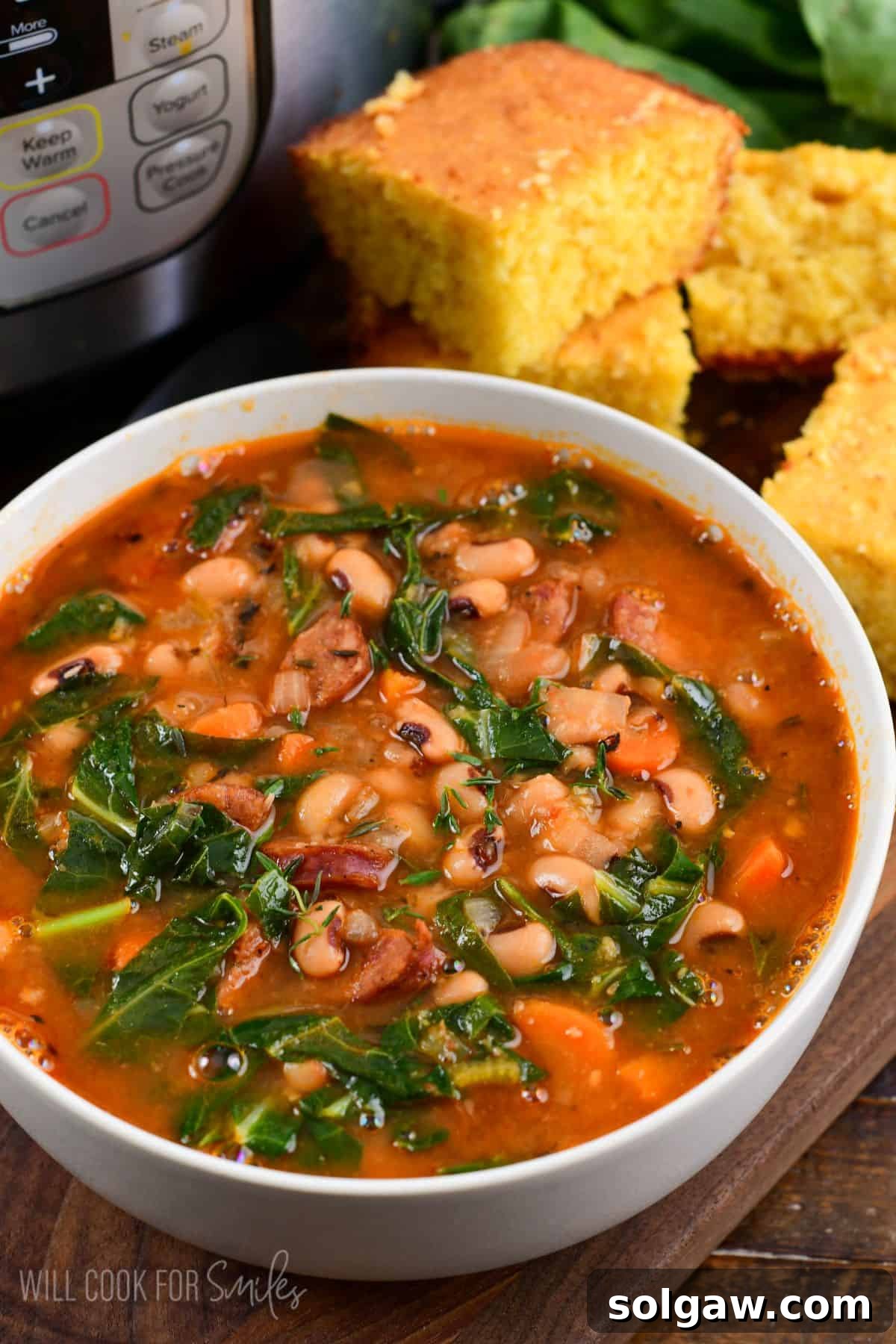 A close-up shot of a warm and inviting bowl of Southern black-eyed pea soup, richly textured with smoky andouille sausage and vibrant collard greens in a savory tomato-based broth. Ideal for a comforting meal.