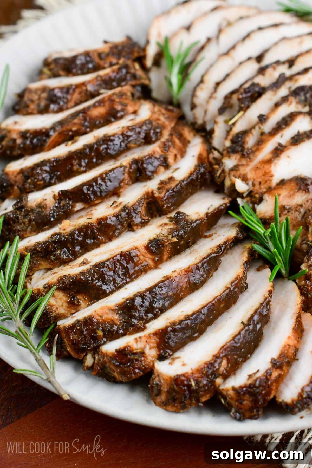 juicy and flavorful turkey tenderloin in a balsamic and Italian seasoning mixture sliced on a platter.