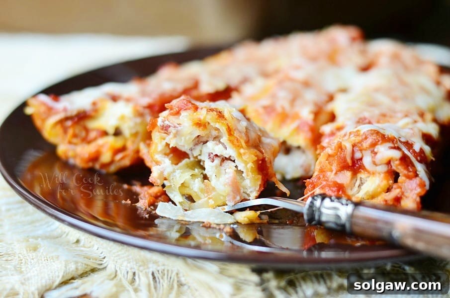 Close-up of Bacon & Caramelized Onion Manicotti, showing the rich filling and golden-brown pasta.