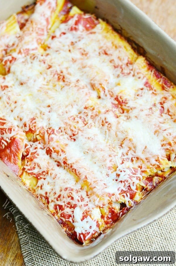A slice of Bacon & Caramelized Onion Manicotti, showcasing its delectable filling and inviting golden crust.
