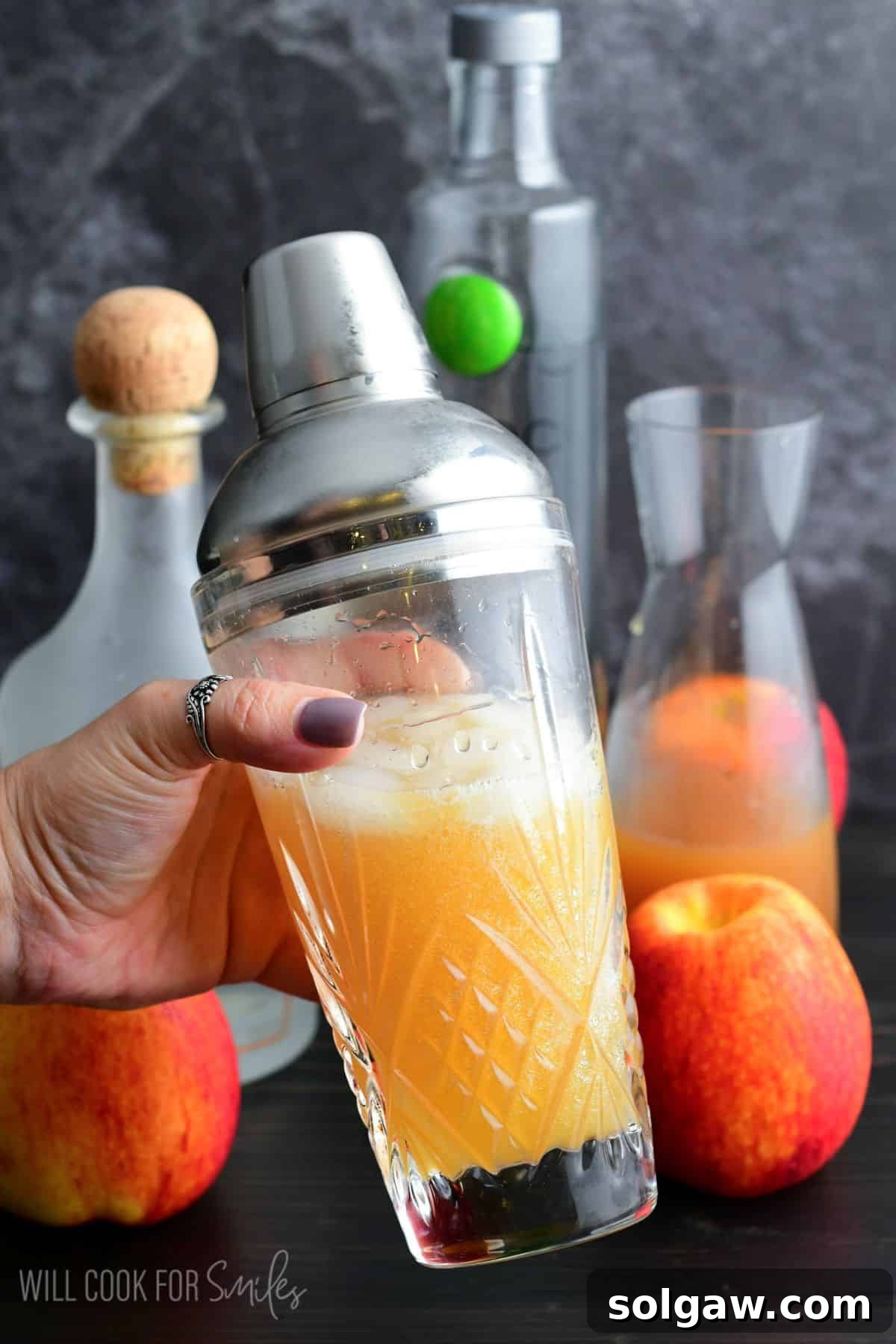 Autumn Orchard Martini 5 A cocktail shaker vigorously mixing an Apple Cider Martini, with fresh ingredients blurred in the background, signaling the lively preparation of a seasonal drink.