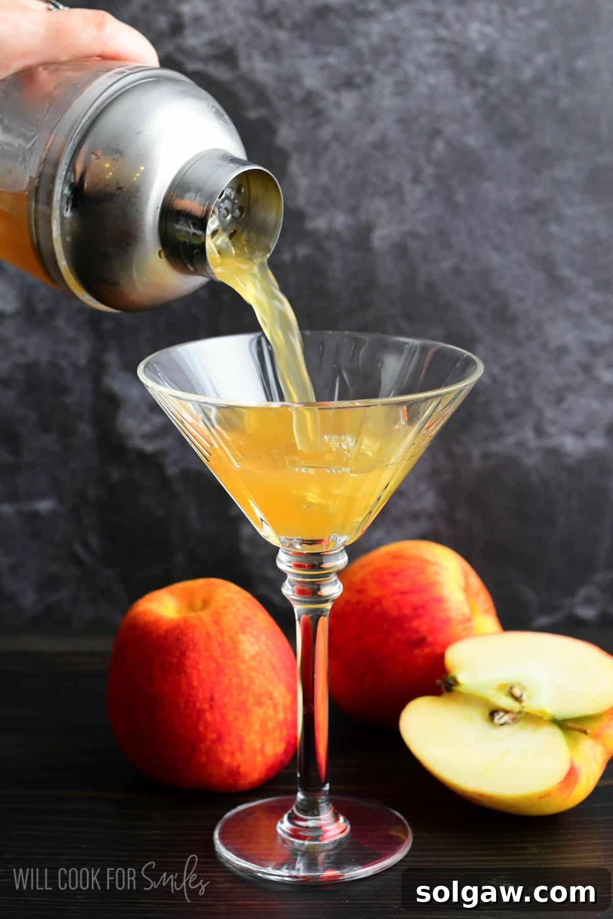 Autumn Orchard Martini 6 Freshly poured Apple Cider Martini in a elegant martini glass, with green apples artfully arranged around the stem, highlighting its crisp and inviting presentation.