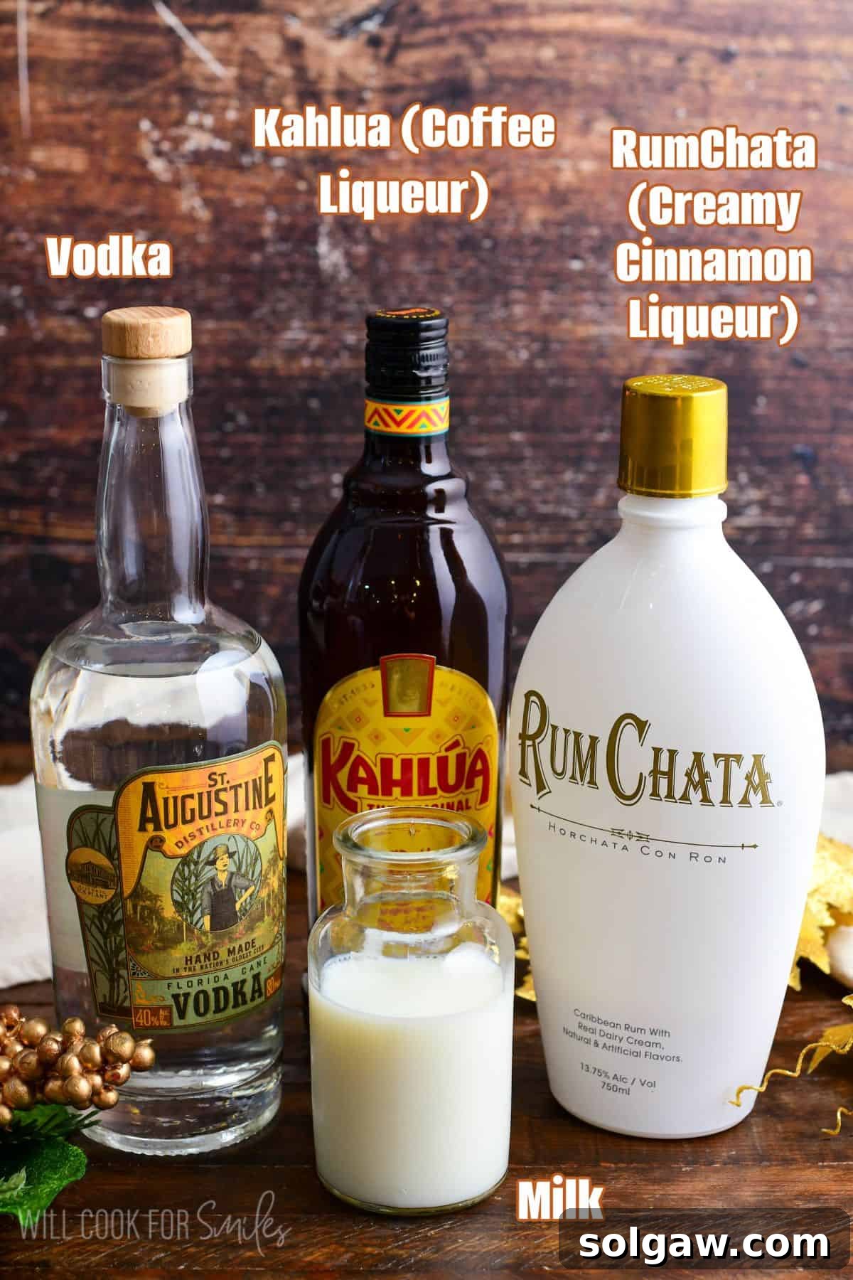 Labeled ingredients for a RumChata cocktail arranged neatly on a rustic wooden surface.