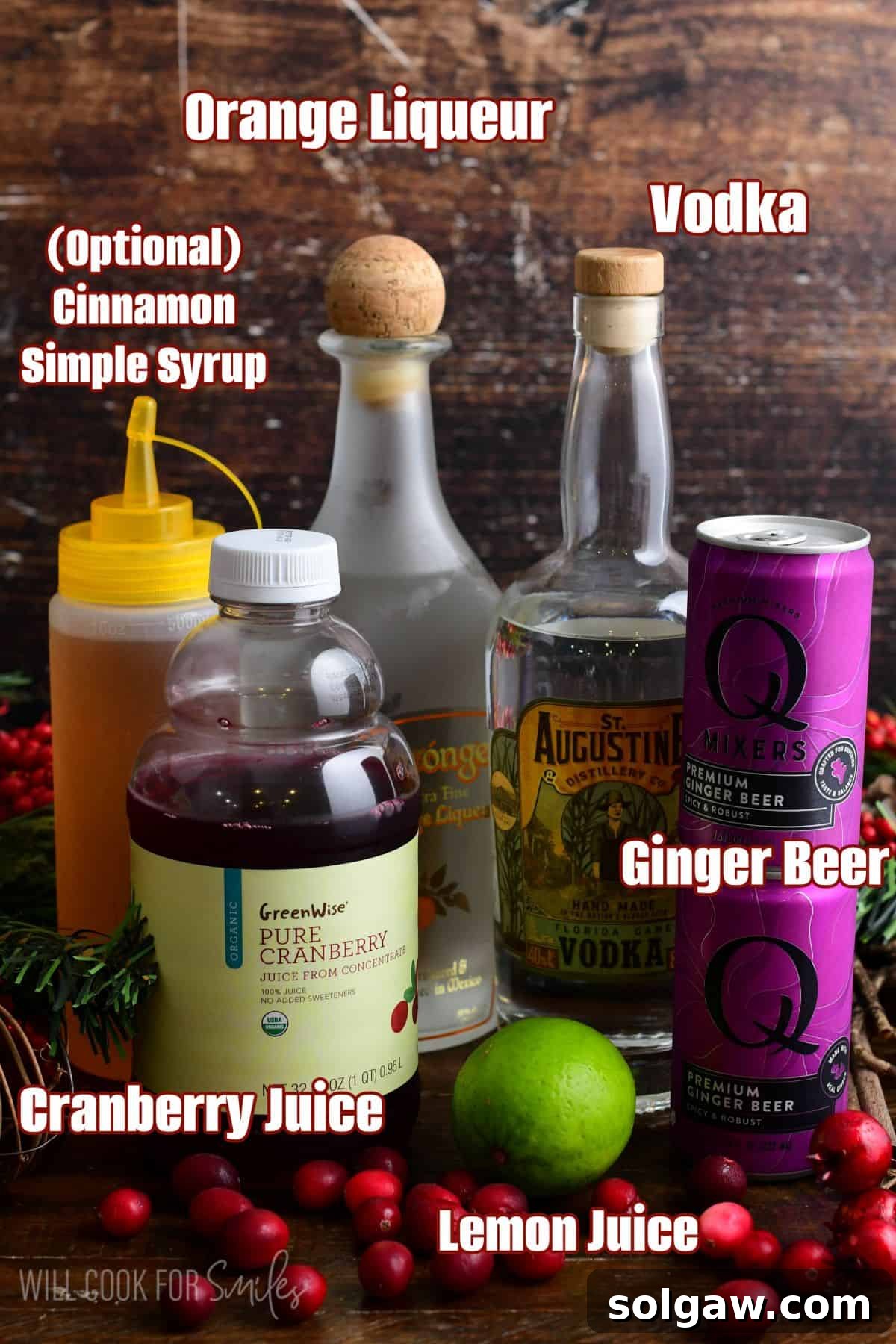 Labeled ingredients for Cranberry Moscow Mule on a wood surface.