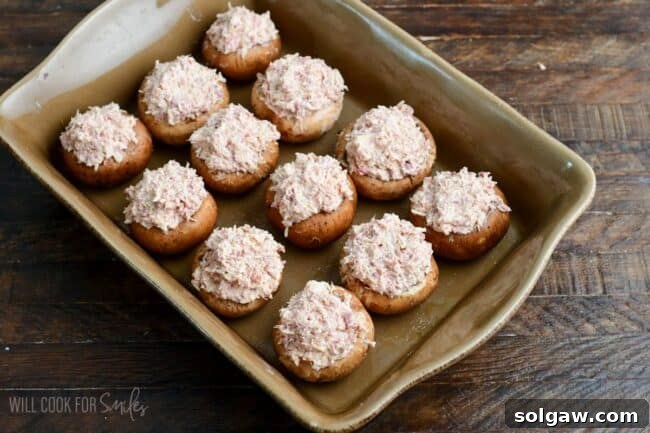 stuffed mushroom camps with Reuben filling in the baking dish.