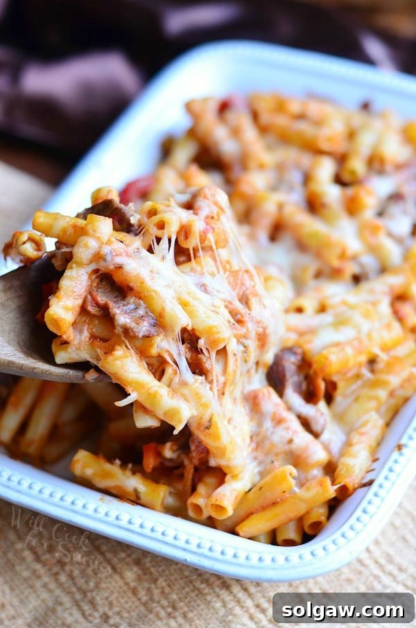 Rich and gooey Italian Cheesesteak Baked Ziti, a comforting pasta dish combining tender steak, bell peppers, onions, and melted cheese with marinara sauce.