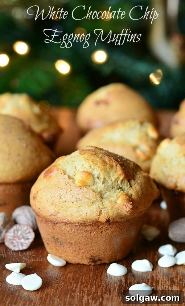 White Chocolate Chip Eggnog Muffins on a table, perfectly baked and golden