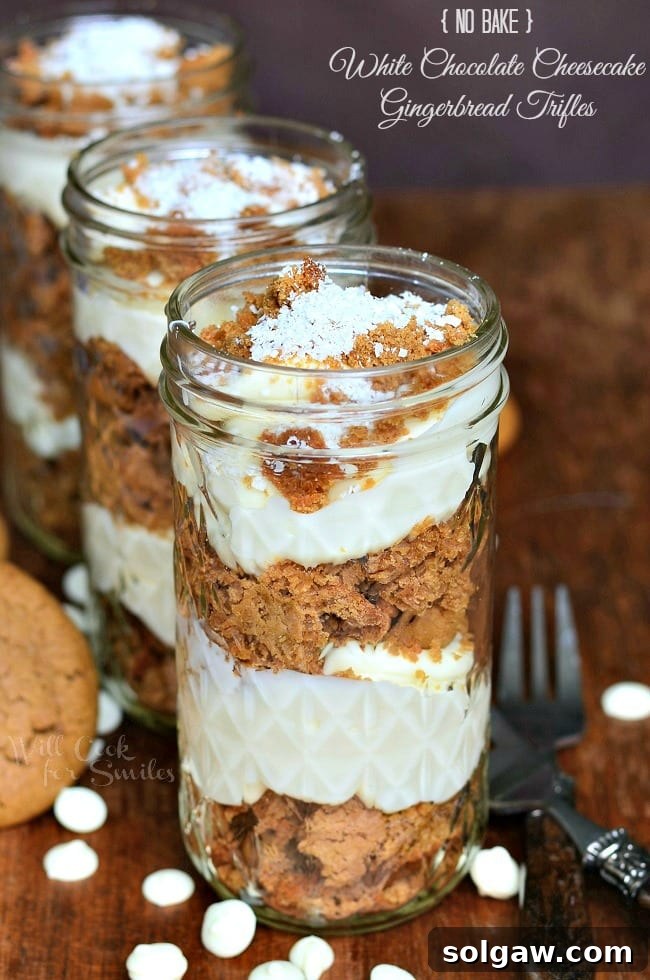 Cheesecake Gingerbread Trifles in mason jars, beautifully layered and ready to serve.