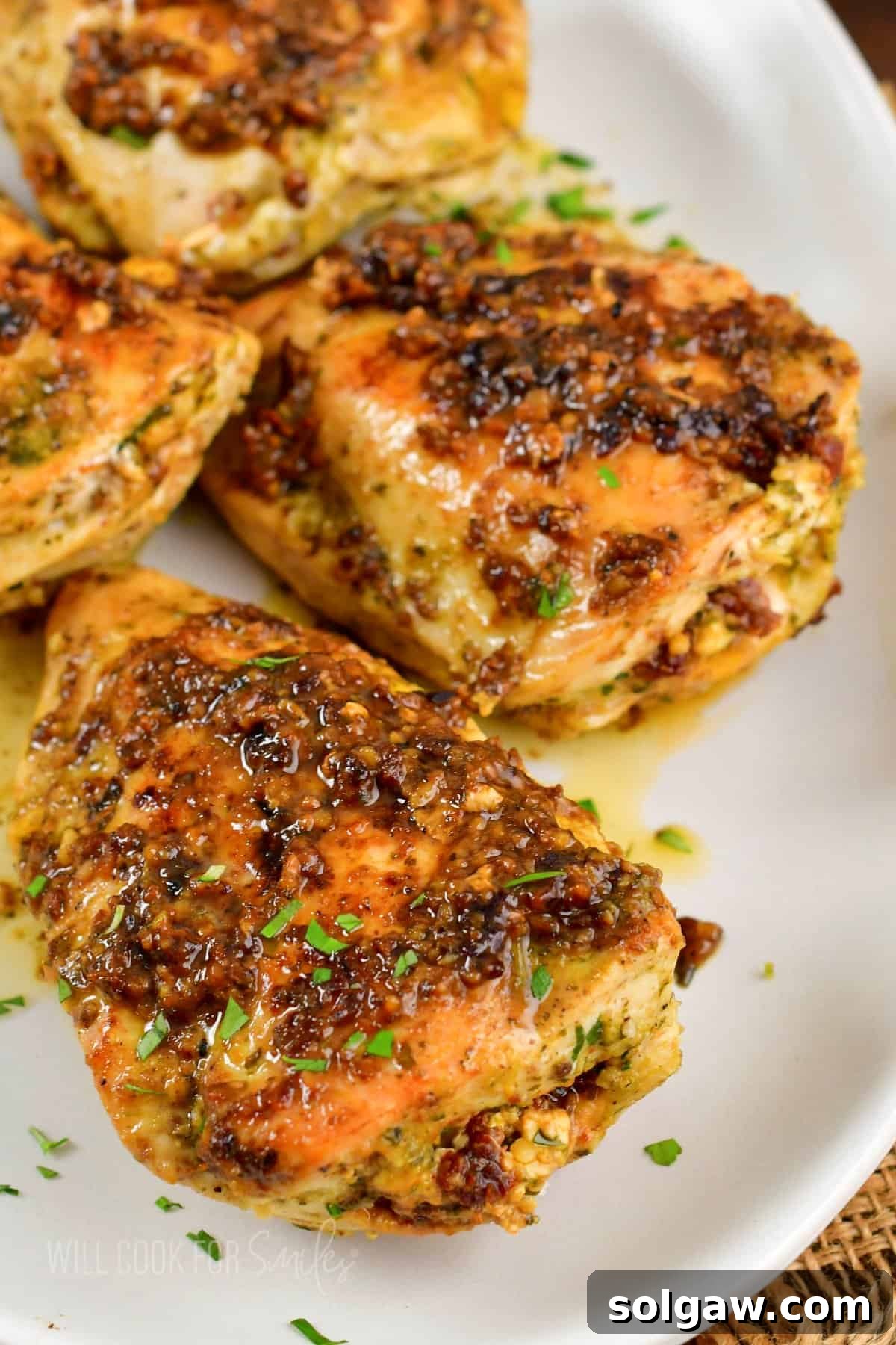 Feta Sun-Kissed Chicken 8 closeup of perfectly cooked and sliced stuffed chicken breasts on a white plate, revealing the rich filling.