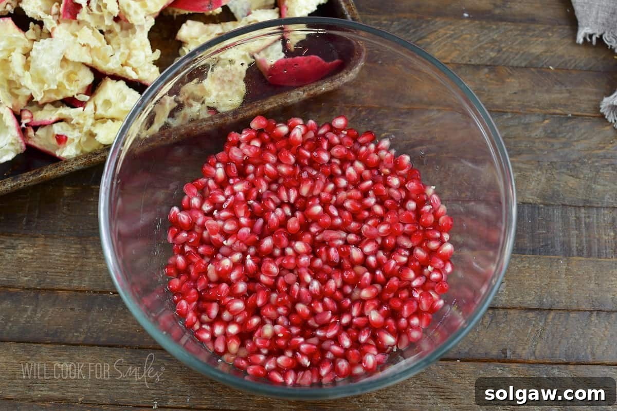 A bowl filled with freshly separated pomegranate seeds, ready for use.